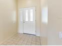 Bright foyer with tiled floors and a large glass front door welcoming you inside at 4486 Gaston St, Spring Hill, FL 34607