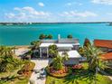 Beautiful single-Gathering home featuring lush landscaping, a well-manicured lawn, and amazing waterfront views at 520 Belle Isle Ave, Belleair Beach, FL 33786