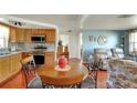 Bright dining area featuring wood table and chairs, with natural light and open flow to kitchen at 9301 Pegasus Ave, Port Richey, FL 34668