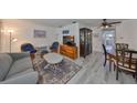 Cozy living room with comfortable seating and light wood-look floors adjacent to the dining area at 10038 62Nd N Ter # 21, St Petersburg, FL 33708