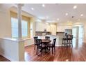 Bright, open kitchen featuring a breakfast nook, white cabinets, and hardwood floors at 14605 Chatsworth Manor Cir, Tampa, FL 33626