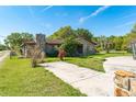 Charming home with a stone chimney and well-maintained lawn in a quiet, green neighborhood at 1501 W Trapnell Rd, Plant City, FL 33566
