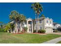 Charming two-story home featuring lush landscaping, a well-manicured lawn and an attached garage at 15618 Shoal Creek Pl, Odessa, FL 33556