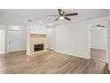 Spacious living room featuring a decorative fireplace and new floors at 18406 Sterling Silver Cir, Lutz, FL 33549