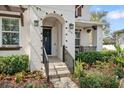Inviting front entrance features decorative archway, attractive landscaping, and modern lighting at 216 N Habana Ave, Tampa, FL 33609