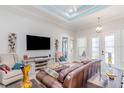 Comfortable living room with entertainment center, leather sofa, and open layout at 2202 Yalta Ter, North Port, FL 34286