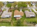 Aerial view of home with well-maintained lawn in a neighborhood with mature trees at 2958 Macalpin N Dr, Palm Harbor, FL 34684