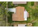 Birds-eye view of home showing roof, driveway, and back patio with manicured lawn at 2958 Macalpin N Dr, Palm Harbor, FL 34684