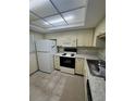 Functional kitchen features classic cabinetry and stainless steel sink at 3046 Eastland Blvd # J106, Clearwater, FL 33761