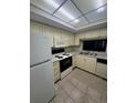 Functional kitchen features classic cabinetry and stainless steel sink at 3046 Eastland Blvd # J106, Clearwater, FL 33761