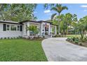 Single-story home featuring a welcoming front porch and a well-manicured lawn at 3520 Poplar Ne St, St Petersburg, FL 33704