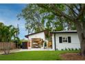 Charming garage with abundant storage, lovely landscaping, and a well-manicured lawn at 3520 Poplar Ne St, St Petersburg, FL 33704