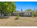 Well-kept single story home with a neat front yard and driveway that leads to a detached garage at 3822 W Euclid Ave, Tampa, FL 33629