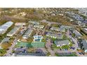 Aerial view of community featuring a pool, tennis courts, and lush landscaping at 455 Alt 19 S Hwy # 81, Palm Harbor, FL 34683