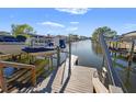 View of the community dock with boat lifts and canal views, offering convenient access to waterways at 4806 Bay Crest Dr, Tampa, FL 33615