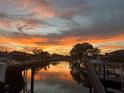 Scenic water view with a beautiful sunset reflected on the water from a neighborhood dock at 4806 Bay Crest Dr, Tampa, FL 33615
