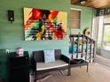 Cozy sitting area with wicker furniture, perfect for relaxing with a book, colorful decorative painting at 4904 E River Hills Dr, Tampa, FL 33617