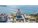 Aerial view of the oceanfront condo building with a pool and parking at 6372 Palma Del Mar S Blvd # 1007, St Petersburg, FL 33715