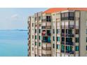 Exterior shot of the condo building featuring many balconies overlooking the tranquil water at 6372 Palma Del Mar S Blvd # 1007, St Petersburg, FL 33715