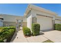 Charming front exterior with a private walkway leading to the entrance and a one-car garage at 767 Tremont Greens Ln # 64, Sun City Center, FL 33573