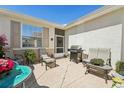Private patio with comfortable seating, a grill, and a view of the surrounding landscape at 767 Tremont Greens Ln # 64, Sun City Center, FL 33573