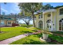 Beautifully landscaped front yard with a brick path leading to the stunning home at 800 Druid S Rd, Clearwater, FL 33756