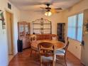 Inviting dining room features a round table with four chairs, a ceiling fan, and wood-look laminate flooring at 8100 Dr Martin Luther King Jr N St # 302, St Petersburg, FL 33702