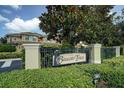 Community entrance featuring the Beacon Trace sign, mature trees and well-maintained landscaping at 13208 San Blas Loop, Largo, FL 33774