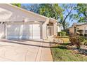 Home with a two-car garage, walkway to the front door, and well-maintained landscaping at 13526 Norman Cir, Hudson, FL 34669
