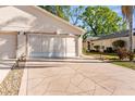 Spacious two-car garage with decorative driveway for ample parking at 13526 Norman Cir, Hudson, FL 34669