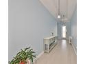 Light blue entryway features ceramic tile flooring, a console table, and a decorative light fixture at 17152 Scuba Crest St, Wimauma, FL 33598