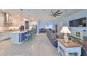 Open-concept living area features ceramic tile floors, high ceilings, and views into kitchen at 17152 Scuba Crest St, Wimauma, FL 33598