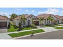 Charming single-story home with a tiled roof, manicured lawn, and inviting curb appeal at 17418 Holly Well Ave, Wimauma, FL 33598