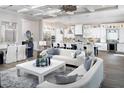 Spacious open-concept living and dining area features bright white sofas and a modern gourmet kitchen at 17716 Roost Pl, Lakewood Ranch, FL 34211