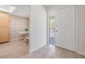 Welcoming foyer features tile flooring and a half glass front door adjacent to a dining area at 2020 Lakeview Dr # 202, Clearwater, FL 33763