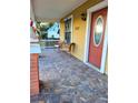 Comfortable front porch with tile flooring and seating, perfect for enjoying the outdoors at 2222 Harper St, Tampa, FL 33605