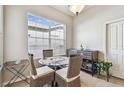 Bright breakfast nook with large windows, seating for four, and a decorative cabinet at 31820 Blythewood Way, Wesley Chapel, FL 33543