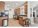 Well-equipped kitchen features stainless steel appliances, tiled floors, and a breakfast bar at 31820 Blythewood Way, Wesley Chapel, FL 33543