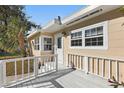 Inviting front porch with white railing, showcasing the entrance to this charming home at 3220 10Th N St, St Petersburg, FL 33704