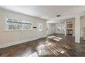 Open-concept living room with stone tile flooring, bright windows, and ample natural light at 3220 10Th N St, St Petersburg, FL 33704