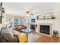 Cozy living room with fireplace, ceiling fan, and large windows that provide natural light and pretty views at 3310 Haviland Ct # 202, Palm Harbor, FL 34684