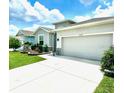 Well-kept home boasts a two-car garage, beautiful landscaping, and a long driveway for added convenience at 33298 Major Oak Dr, Wesley Chapel, FL 33545