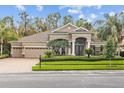 Inviting home exterior featuring a three-car garage and meticulously maintained front yard at 3543 Watermark Dr, Wesley Chapel, FL 33544