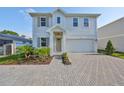 Charming two-story home with landscaped yard and brick paved driveway at 3915 W Euclid Ave, Tampa, FL 33629