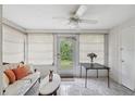 Bright sunroom featuring tiled floors, and multiple windows offering natural light and views of the outdoors at 4235 Richmere Dr # 4235, New Port Richey, FL 34652