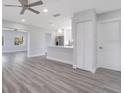 Open-concept space featuring new gray wood floors connecting the living room to the kitchen at 4509 26Th S Ave, Tampa, FL 33619