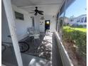 Relaxing screened-in porch with ceiling fan, table, and chairs at 46 Washington Ct # 28, Palm Harbor, FL 34684