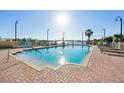 Enjoy the scenic pool and tanning deck with lounge chairs and waterfront view on a sunny day at 700 N Osceola Ave # 504, Clearwater, FL 33755
