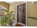 Charming front door with a decorative wreath and 'home sweet home' welcome mat at 10115 Courtney Palms Blvd # 202, Tampa, FL 33619