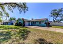 Inviting home with vibrant landscaping, a well-kept lawn, and a spacious driveway at 11492 60Th Lane, Pinellas Park, FL 33782